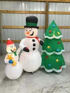 Snowmen decorating tree
