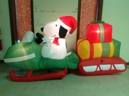 Snoopy on snowmobile w/ presents