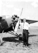 1931 white shirt and tie with hand on propeller (retouched). Circa 1931. There is no emblem on the engine housing.