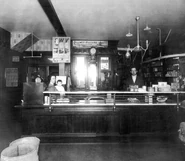 1907 circa Lizzie Alberta Miller holding Weldon) and James Carruthers Borland in family store