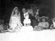 Margaret & Joseph cutting the cake at their wedding (1948)