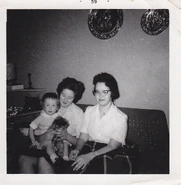 Faith holding her sister Kathy, with Lauralee sitting beside.
