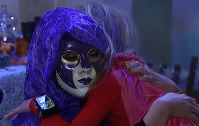 A masked Robin Scorpio hugs her daughter Emma Scorpio-Drake (2013)