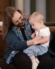 Laura holds her youngest grandchild, Ace (2023)