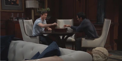 Son and father, Spencer and Nikolas, play chess (2021)