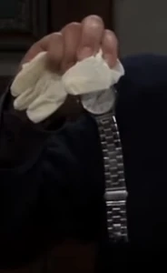 Dante holds Nikolas' watch (2023)