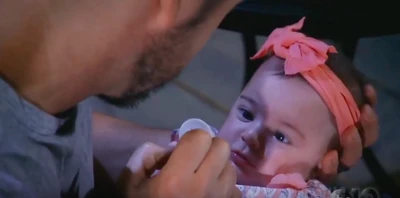 Julian teases Scout with her pacifier