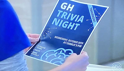 Elizabeth Baldwin holds a Trivia Night flyer for Charlie's Pub (2021)