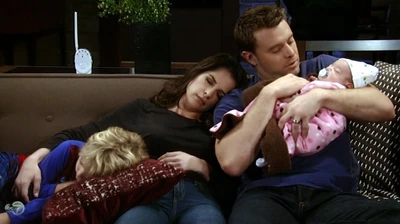 Scout cuddles with her parents and big brother, Danny