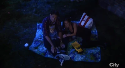 Patrick, Sam McCall and her son Danny Morgan watch fireworks in the park