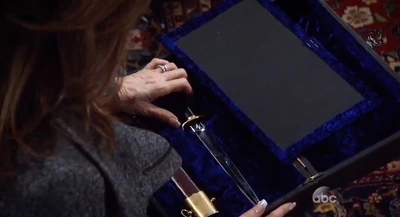 Alexis opens the box to find a dagger (2016)