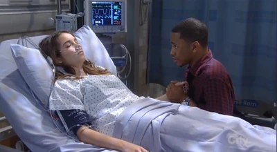 T.J. holds Molly's hand in the hospital (2014)