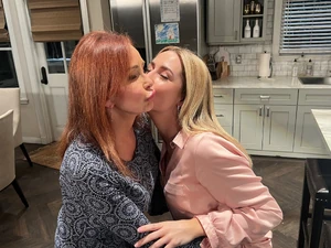 Grandmother and granddaughter embrace (2023)