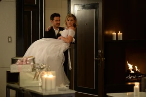 Nathan carries Maxie over the threshold