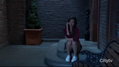 Willow sits on the stoop outside Charlie's Pub (2023)