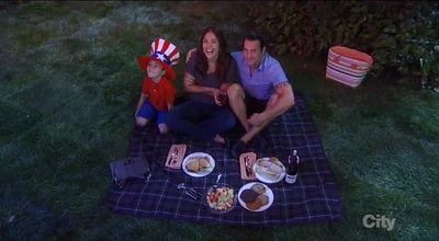 Nikolas, Britt, and Spencer watch fireworks in the park