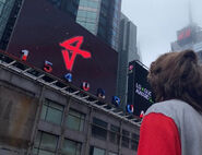 A photo of Ranboo looking at the billboard, containing the Generation Loss logo[29].