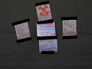 Four papers are taped to a wall, one containing a red drawing of the Showfall logo that has been crossed out and has the word "LIES" written underneath it. The other papers say "DO NOT WATCH", "IT ISN'T A SHOW", and "IT ISN'T FOR US".