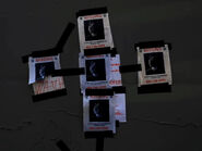Four identical missing posters depicting a masked person taped on top of the other papers.