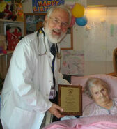 Presents Delma Kollar (aged 112) with an honorary SRF plaque in September 2010