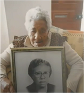 Inacia Carmelino with an old picture of herself.