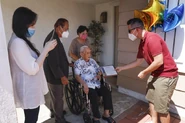 Khen Ngo (aged 109) in wheelchair, receives a city proclamation from San Diego City Councilman Chris Cate (right), while Ngo’s family members look on, including daughter Quy Tran (left), son John Ngo (second from left), and John's wife, Hieu Ngo on 20 September 2020