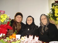 Maria Mihai (center) on her 100th birthday in 2013.