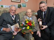 Smith celebrating his 110th birthday in 2018 with Councillor Angus Forbes and Lewis Heriot Maitland, Deputy Lord Lieutenant of Perth and Kinross