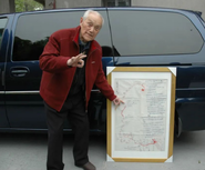 Zhang Lixiong in an undated photo, with a Long March map he drew.