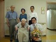 Okawa (aged 113), with her son Hiroshi and other relatives.