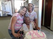 Celsa dos Santos at the age of 110, pictured with two of her children