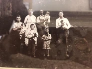 As a young boy (on the left holding a puppy)