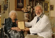 Dr. Stephen Coles presents Soledad Mexia with an honorary SRF plaque in August 2010.