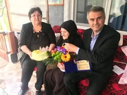 Maria Mihai (center) on her 106th birthday in 2019.