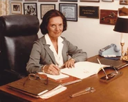 Hesselbein (age 62) in the Halston Girl Scout Uniform at her desk in early 1978.
