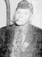 Riddle (age 100) smoking a cigar on his 100th birthday on April 16, 1946 wearing his same hat he wore during Gettysburg.