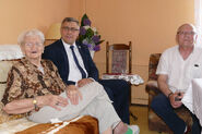 Juniewicz (aged 113) in June 2019, being visited by the marshall of Silesia Voivodeship. Her grandson Adam Stachowski is on the right.
