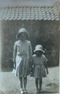 Elsie (aged 12, left) with her Niece Joyce (right) in the back yard