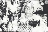 Farris-Luse at the age of 98, holding her two dogs.