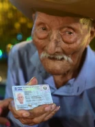 Aged 110, holding up his ID card