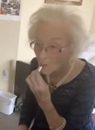 Ceccarelli on her 113th birthday in 2021, putting on her own lipstick