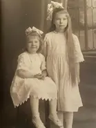 Around 1918, on the left, with her sister