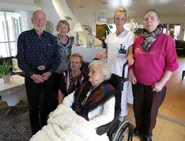 Lindefjeld (sitting, center right) on her 110th birthday with her children Arthur (far left), Agnes (left), and Martine (left, sitting) and her niece Solveig (far right)