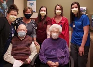 Esther Wittenburg (aged 112) and her 92-year-old son Virgil Bock with clinic staff in April 2021.