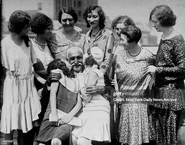 Aga (front, age claimed 156) being kissed by flappers at the Commodore Hotel on July 20, 1930.