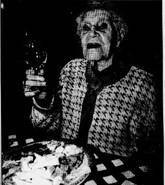 Hulmes (age 108) celebrating her 108th birthday with a glass of bubbly on her 108th birthday on October 5, 1995.