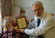 Dr. Stephen Coles presents Frederica Sagor Maas with an honorary SRF plaque.