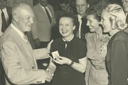 Lois Leyda receives an honor from President Dwight D. Eisenhower.