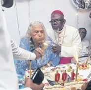 Catherina Mba on her 100th birthday in 2018 with Bishop Basile Mvé :
