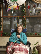 Dunlap holding balloons on her 114th birthday